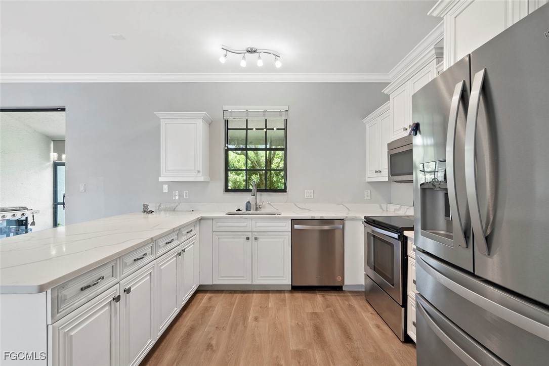 14617 Sutherland Avenue, Unit 80 Naples, FL 34119 - Photo 10 of 46 a kitchen with a refrigerator sink and stove