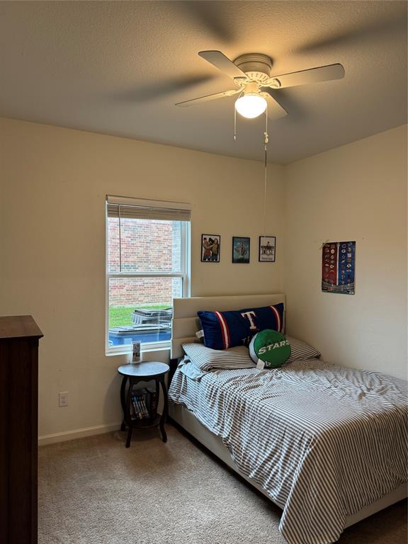 2209 Cinnamon Spgs Road Glenn Heights, TX 75154 - Photo 19 of 28 Carpeted room featuring a ceiling fan with integrated lighting, a window with blinds, and light-colored walls