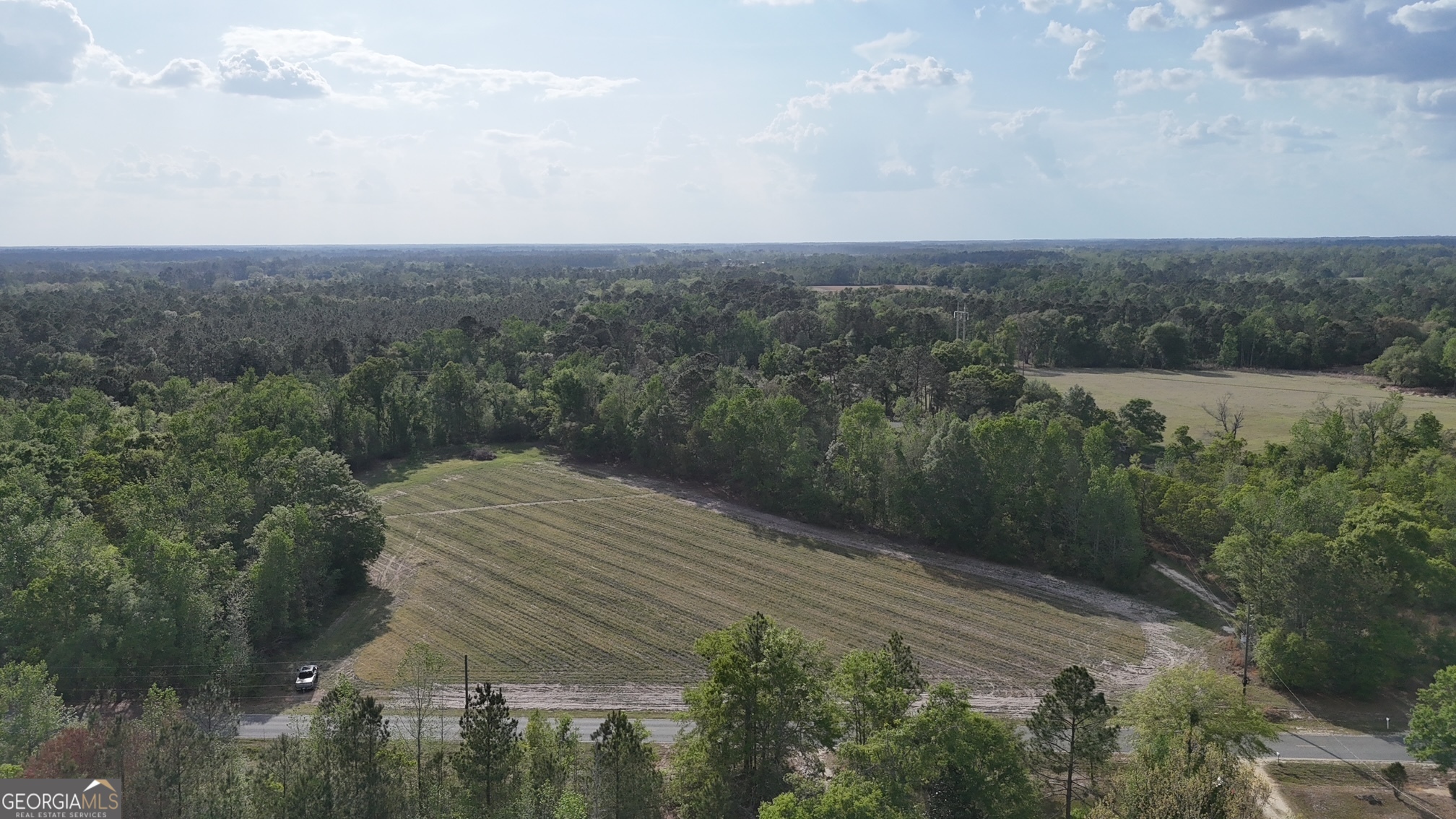 an aerial view of house with yard and mountain view in back