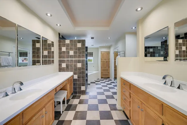 a kitchen with a sink a refrigerator and cabinets