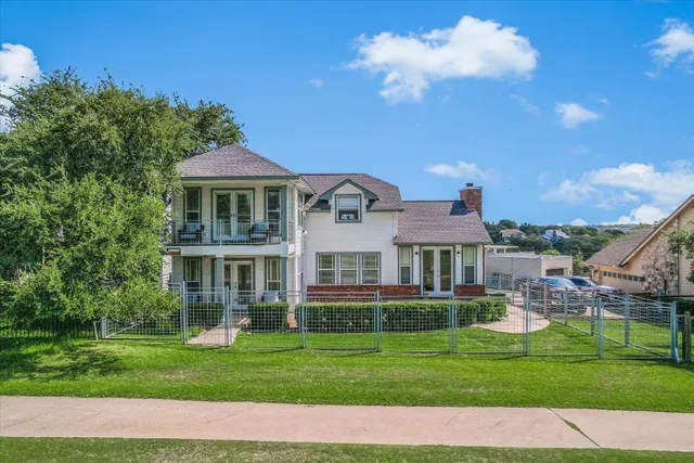 an aerial view of residential houses with outdoor space and street view