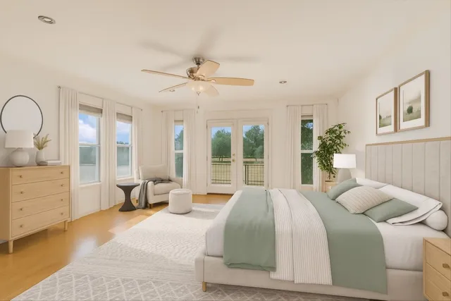 a bedroom with a large bed and windows