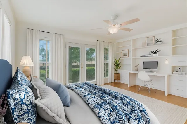 a spacious bedroom with a large bed and a chandelier