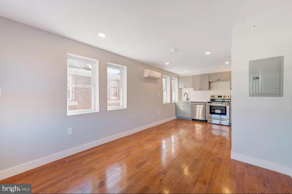4508 Walnut Street, Unit 402 Philadelphia, PA 19139 - Photo 5 of 14 a view of kitchen with wooden floor and electronic appliances