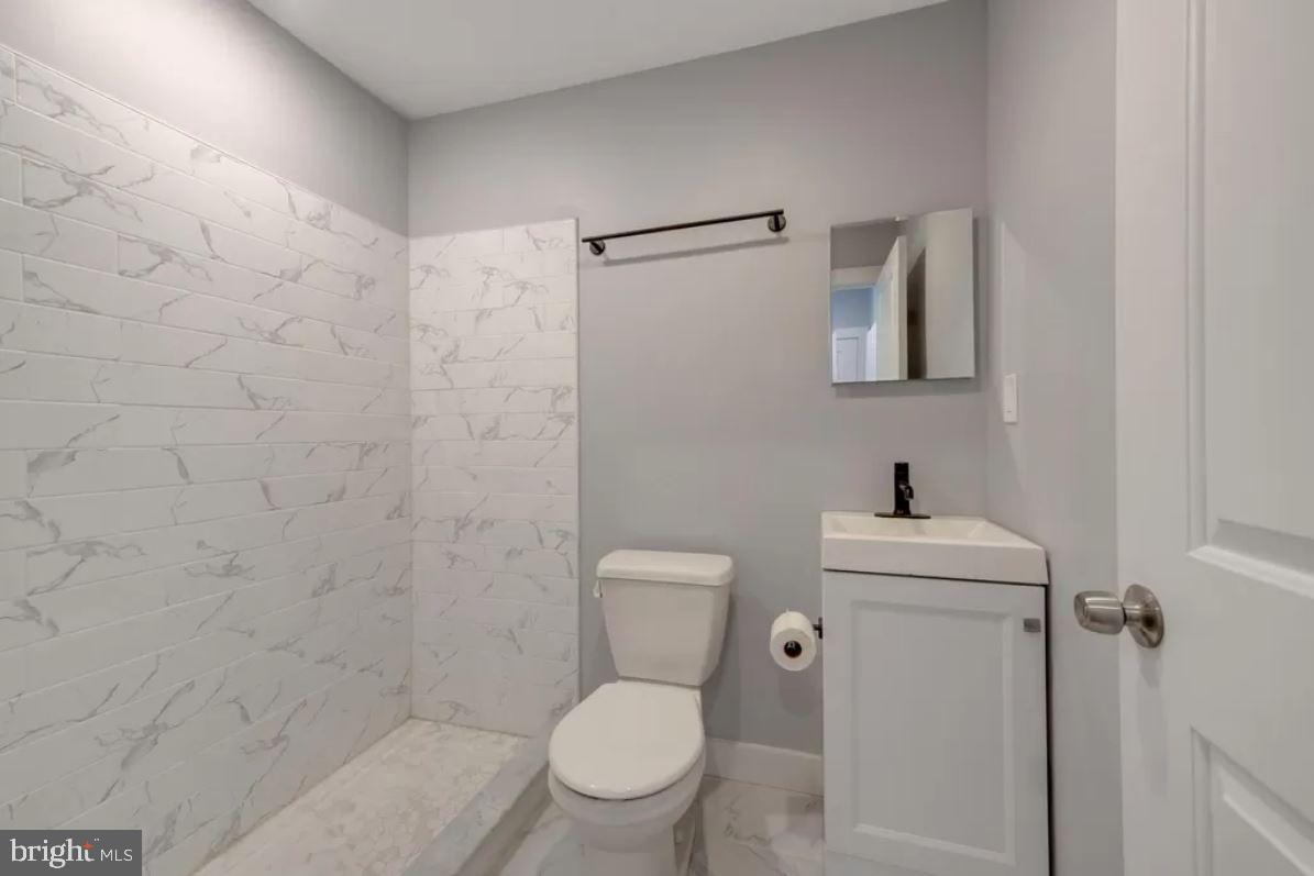 4508 Walnut Street, Unit 402 Philadelphia, PA 19139 - Photo 9 of 14 a white toilet sitting next to a bathroom sink