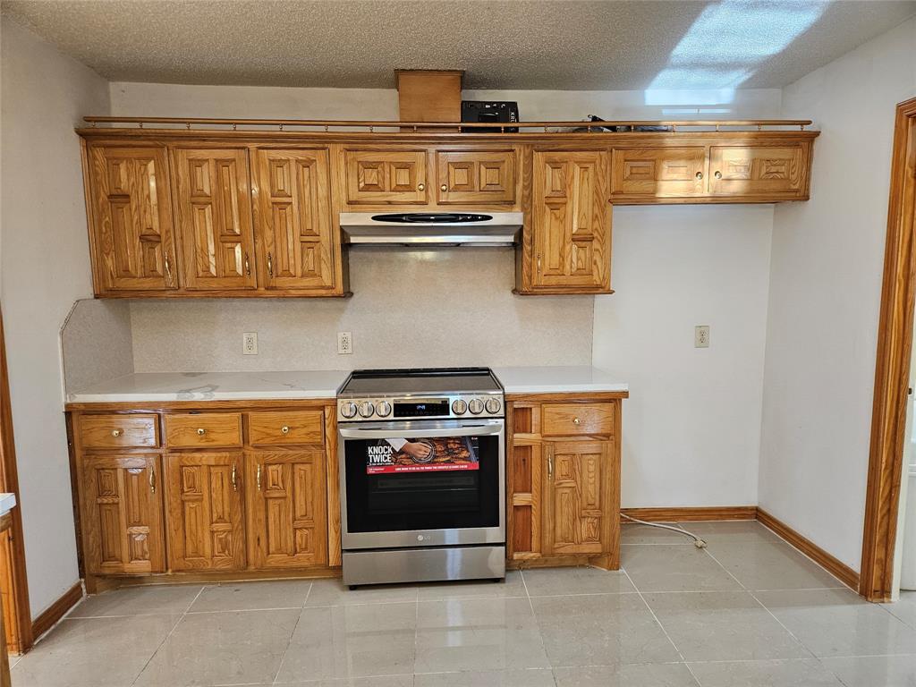 234 East Fork Road Sunnyvale, TX 75182 - Photo 7 of 32 a kitchen with stainless steel appliances granite countertop a stove and a microwave