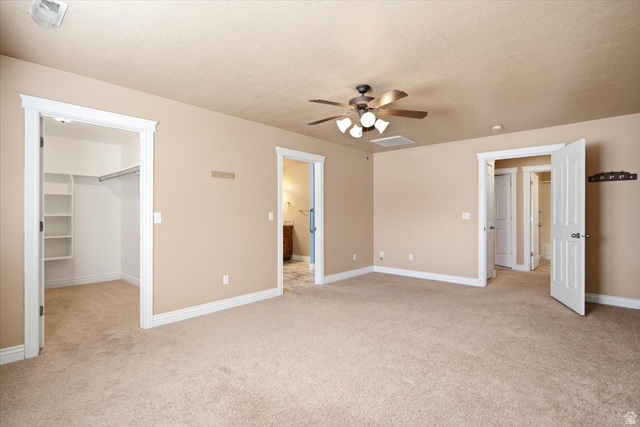 1089 West 2325th Street North Layton, UT 84041 - Photo 18 of 40 Carpeted room with a ceiling fan, recessed lighting, and a walk-in closet featuring built-in shelving and a clothing rod