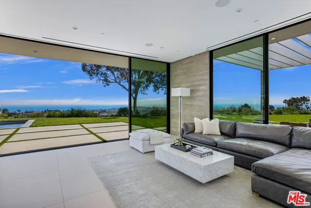 a patio with patio couch and a floor to ceiling window