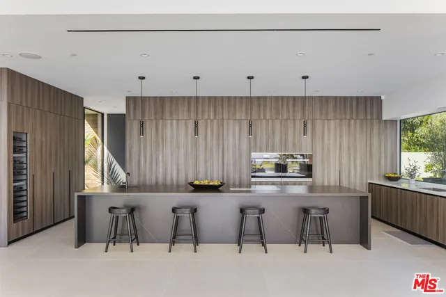 a kitchen with stainless steel appliances a table and chairs