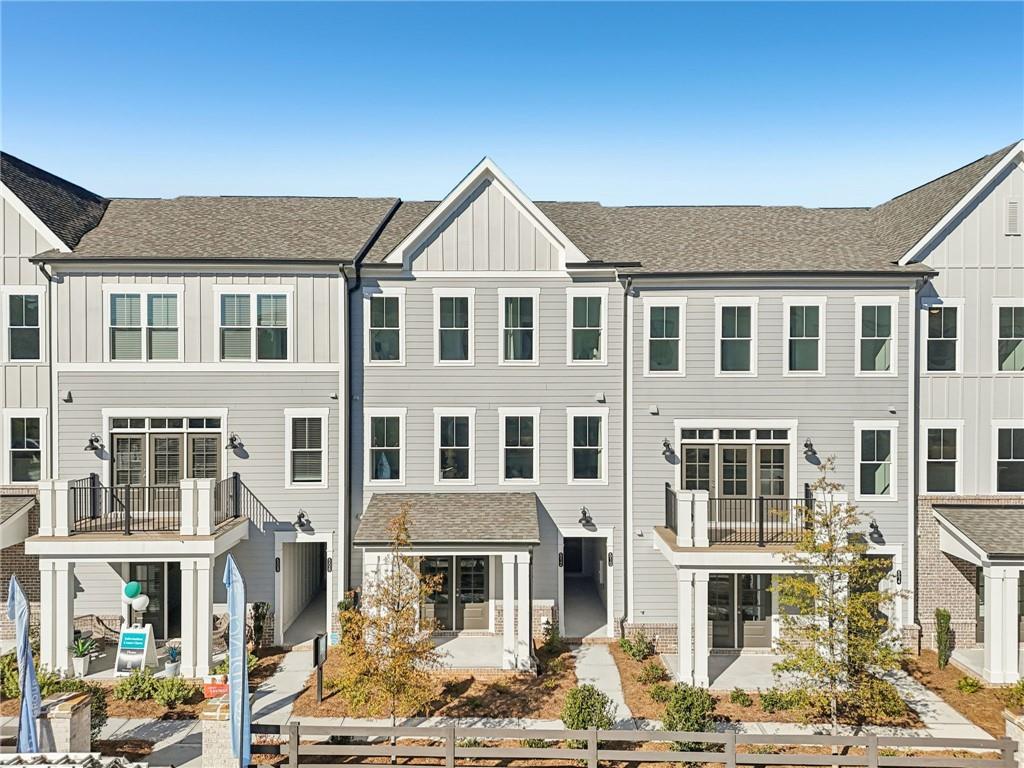a front view of a residential apartment building with a yard