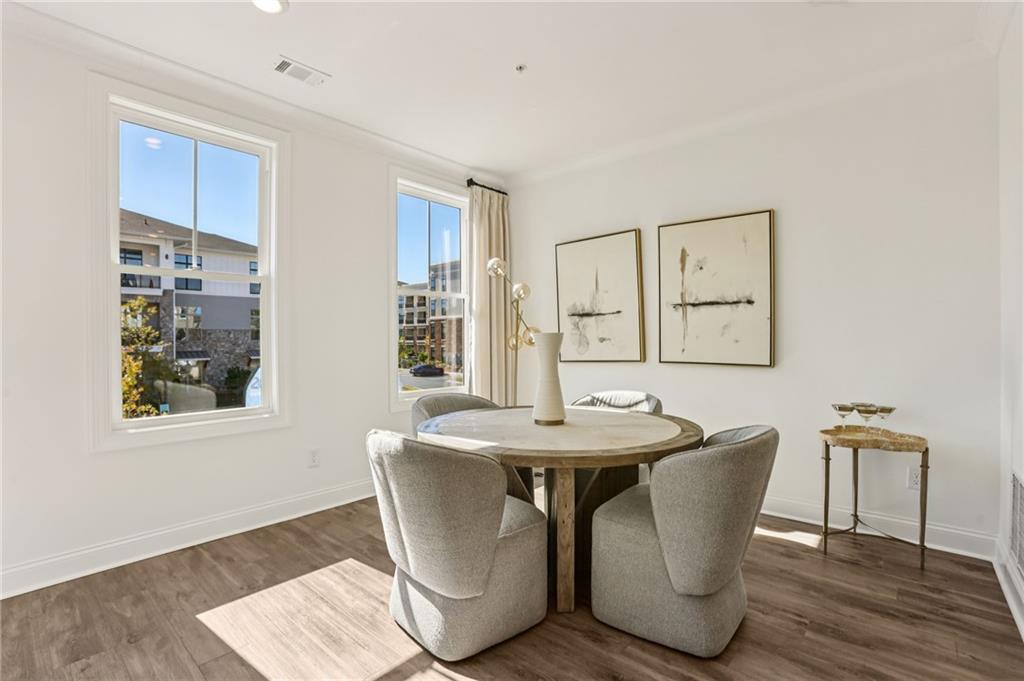 532 Alice Way, Unit D8 Cumming, GA 30040 - Photo 12 of 40 a dining room with wooden floor and large windows