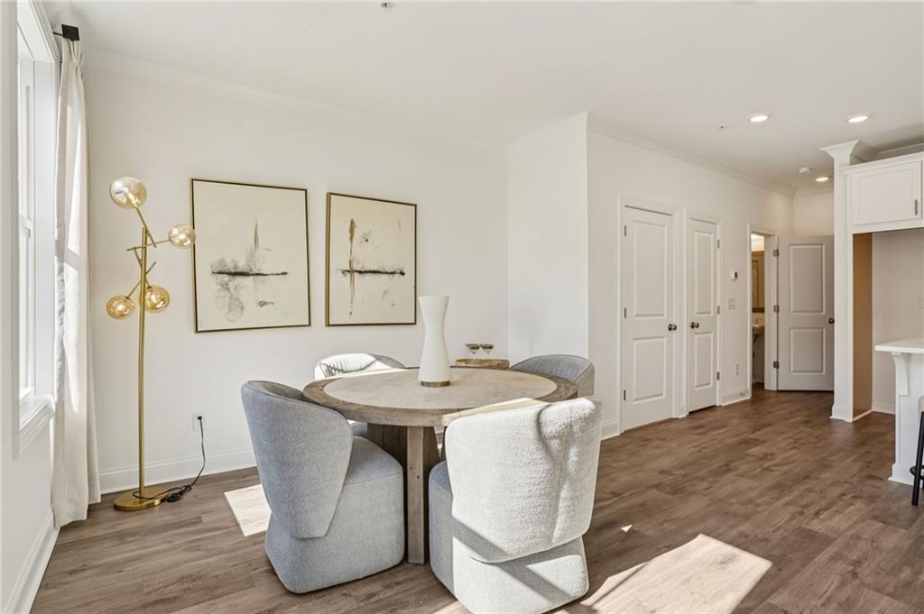 532 Alice Way, Unit D8 Cumming, GA 30040 - Photo 13 of 40 a dining room with stainless steel appliances kitchen island granite countertop a dining table and chairs