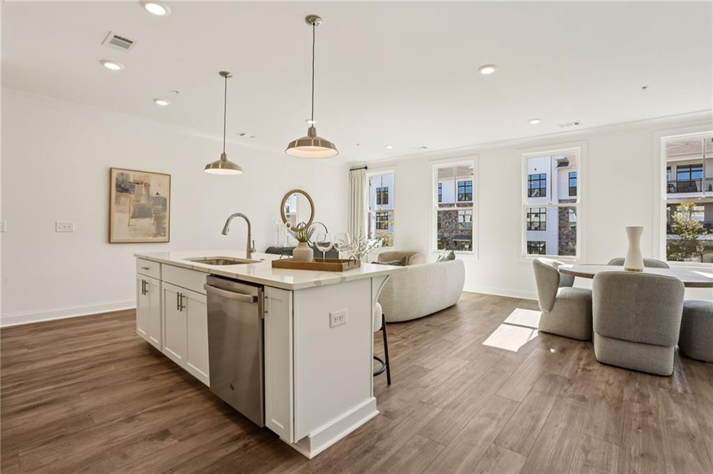 532 Alice Way, Unit D8 Cumming, GA 30040 - Photo 15 of 40 a large white kitchen with a large window