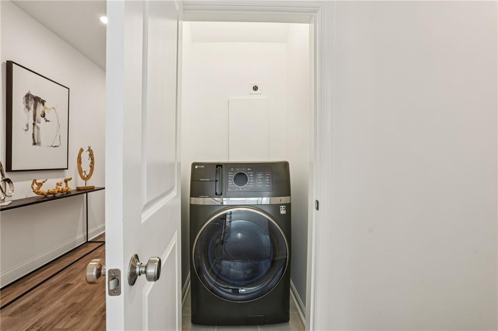 532 Alice Way, Unit D8 Cumming, GA 30040 - Photo 23 of 40 a view of a hallway with washer and dryer