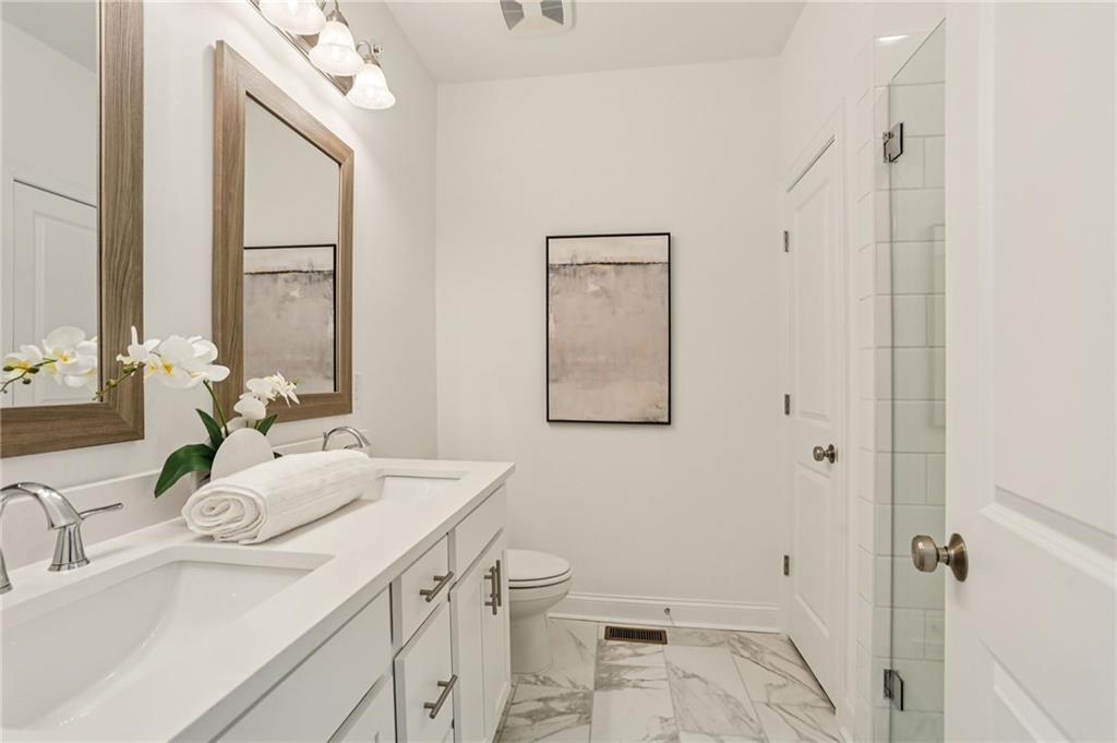 532 Alice Way, Unit D8 Cumming, GA 30040 - Photo 25 of 40 a bathroom with a sink and a mirror