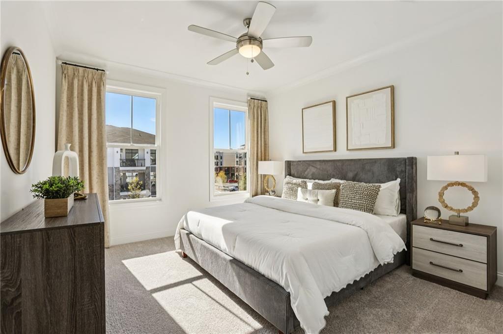 532 Alice Way, Unit D8 Cumming, GA 30040 - Photo 29 of 40 a bedroom with a large bed and a chandelier