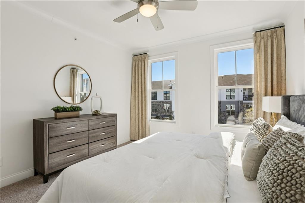 532 Alice Way, Unit D8 Cumming, GA 30040 - Photo 30 of 40 a bedroom with a bed and a dresser