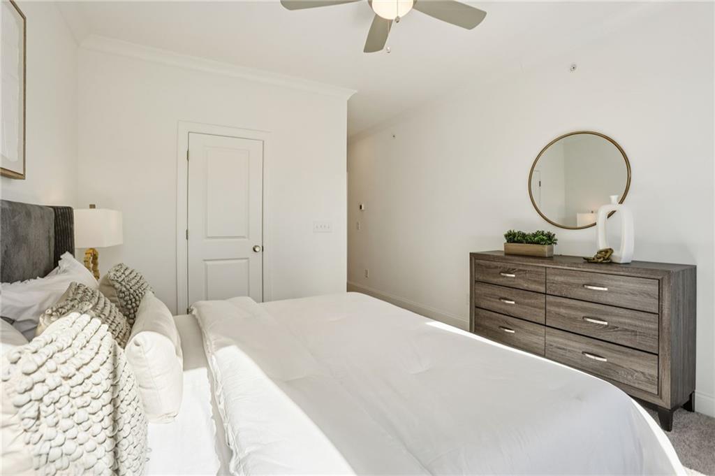 532 Alice Way, Unit D8 Cumming, GA 30040 - Photo 32 of 40 a bedroom with a bed and a mirror