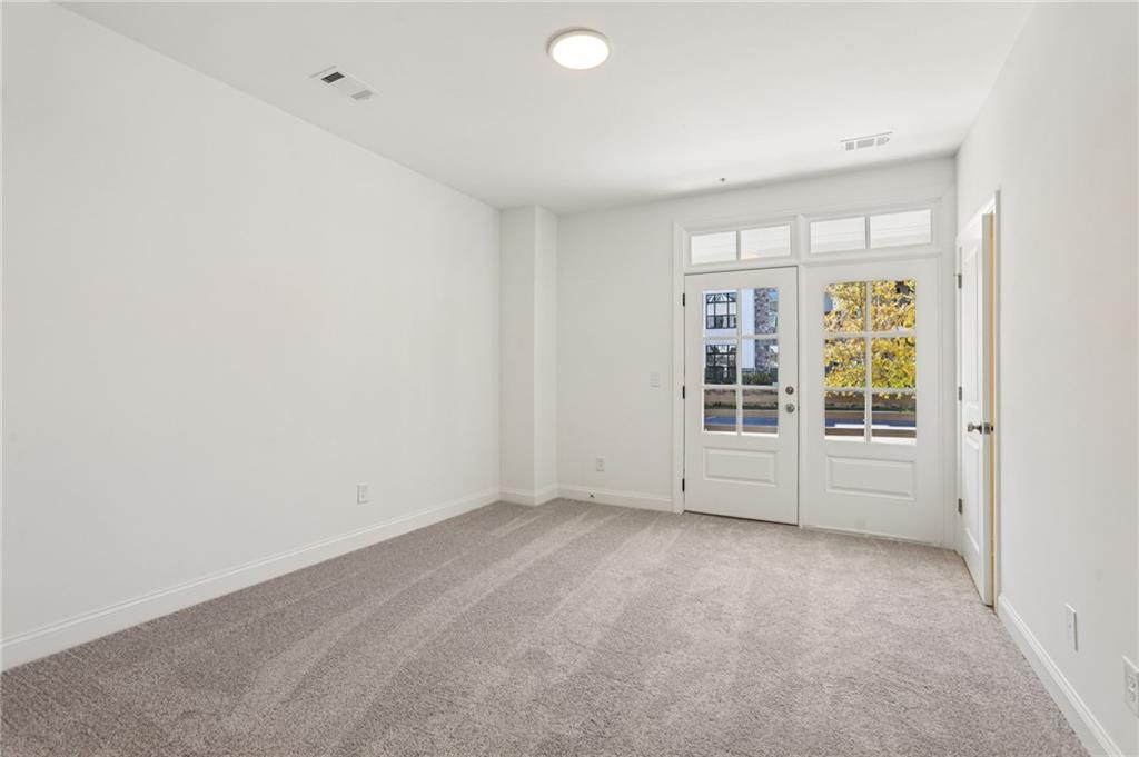 532 Alice Way, Unit D8 Cumming, GA 30040 - Photo 5 of 40 an empty room with a window