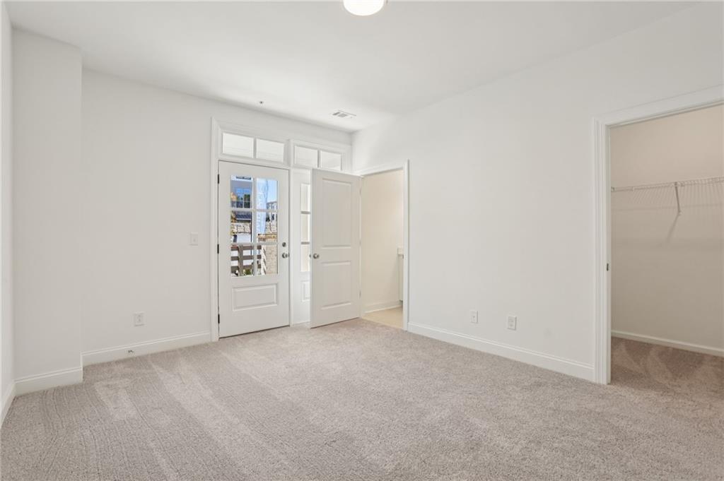 532 Alice Way, Unit D8 Cumming, GA 30040 - Photo 6 of 40 a view of an empty room with a window