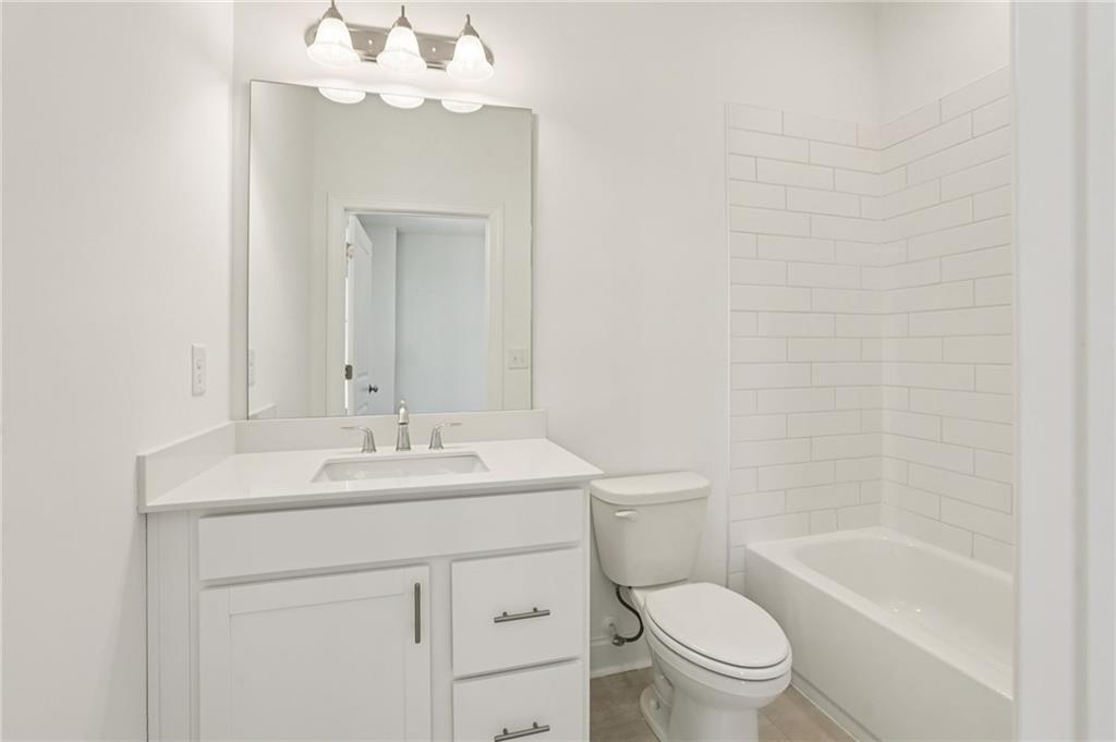 532 Alice Way, Unit D8 Cumming, GA 30040 - Photo 7 of 40 a bathroom with a sink a toilet and shower