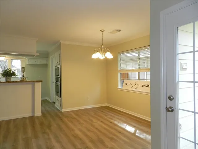 a view of a room with wooden floor and windows