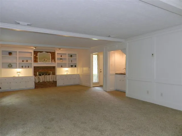 a view of a big room with wooden cabinet and a fireplace