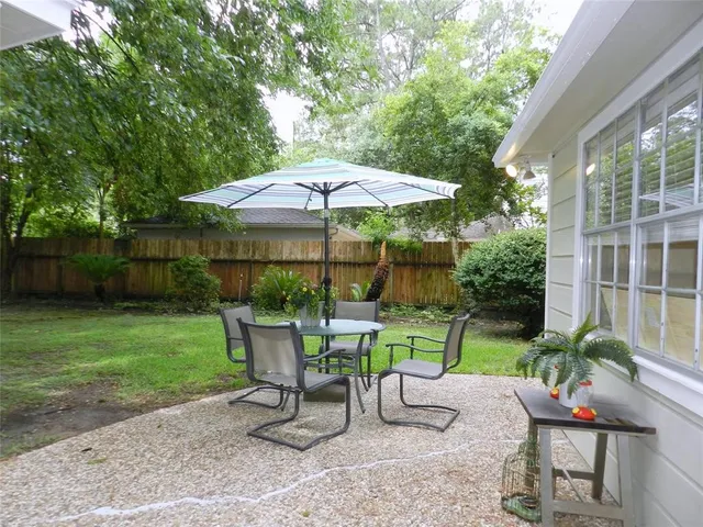 a view of a chair and table under an umbrella