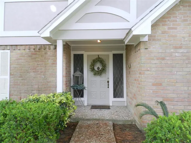 a view of a brick house with potted plants