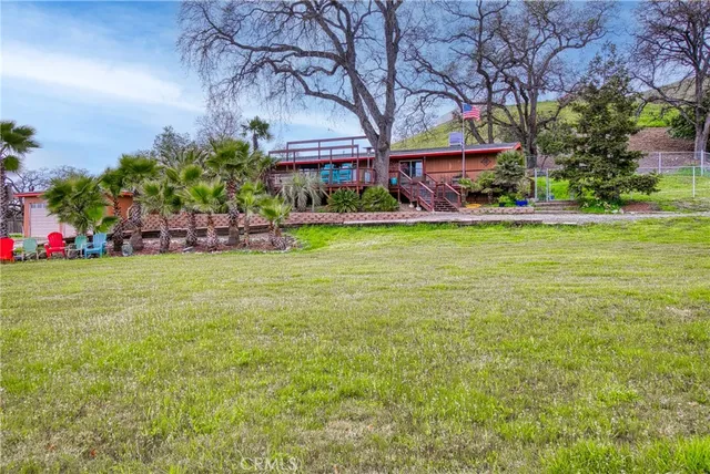 a view of a house with a yard and a garden