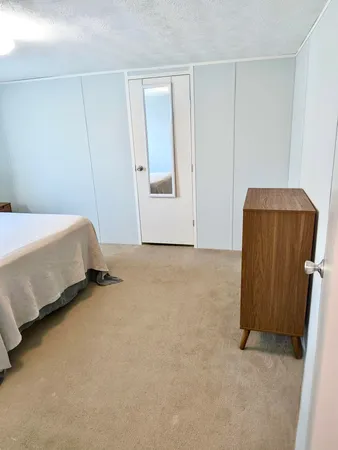 a bedroom with a bed and a cabinets