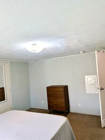 a bathroom with a granite countertop sink and a toilet