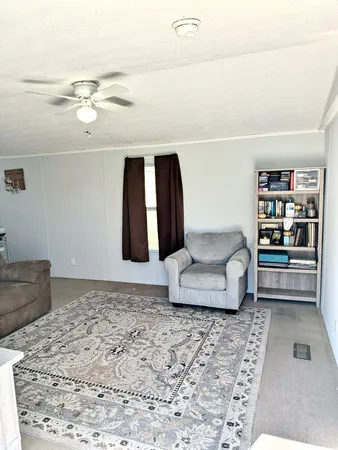 a living room with furniture and floor to ceiling window