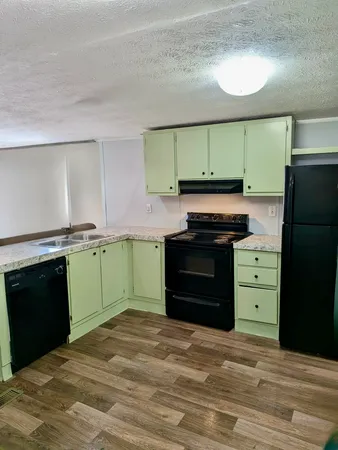 a kitchen with a refrigerator and a stove