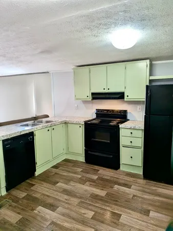 a kitchen with a refrigerator and a stove