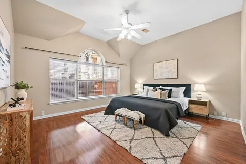 a spacious bedroom with a bed and a large window