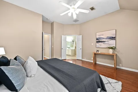 a bedroom with a bed and wooden floor