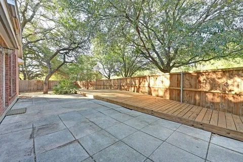 a view of backyard with large trees