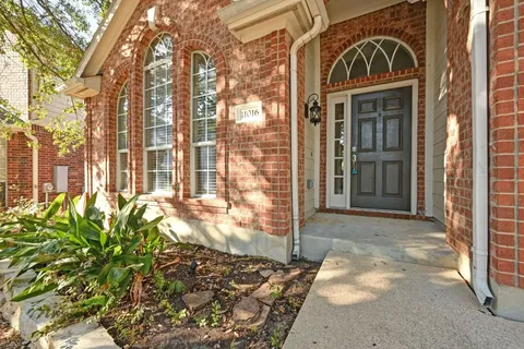a view of a brick house with a large window