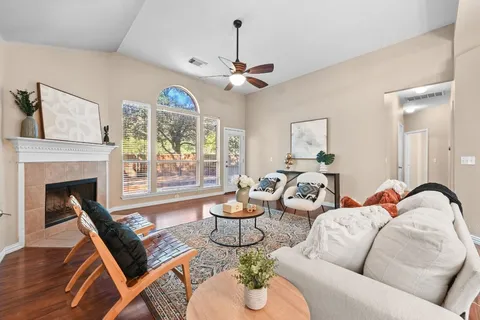 a living room with furniture a fireplace and a chandelier