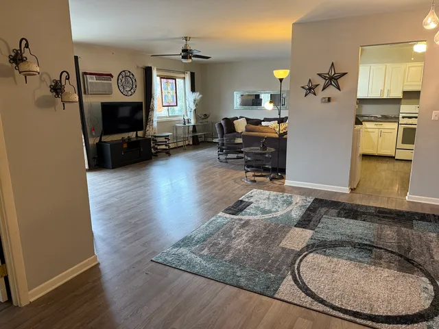 a living room with furniture and wooden floor