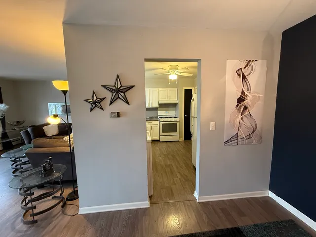 a kitchen with stainless steel appliances white cabinets and a window