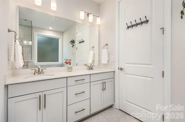 a bathroom with a double vanity sink mirror and