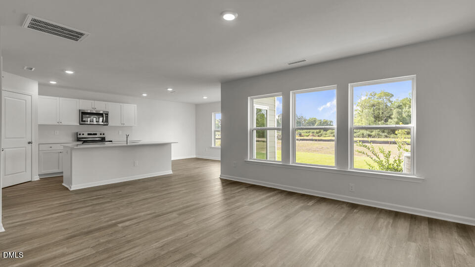 629 Stream Walk Crossing Wendell, NC 27591 - Photo 13 of 38 a view of kitchen with wooden floor and electronic appliances