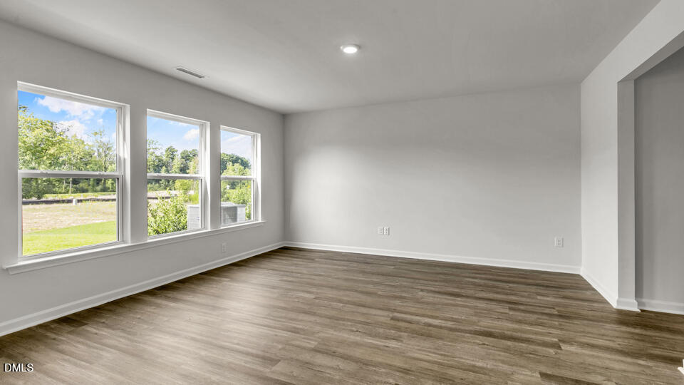629 Stream Walk Crossing Wendell, NC 27591 - Photo 14 of 38 a view of an empty room with wooden floor and a window
