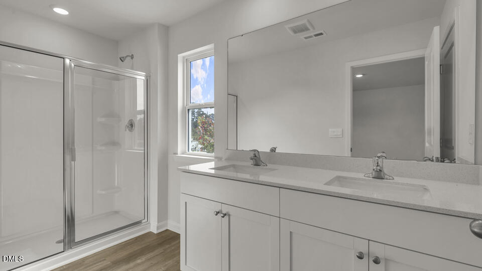 629 Stream Walk Crossing Wendell, NC 27591 - Photo 21 of 38 a bathroom with a shower sink vanity and mirror