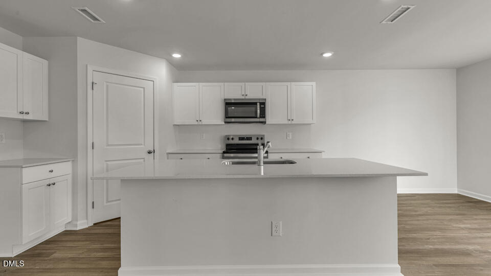 629 Stream Walk Crossing Wendell, NC 27591 - Photo 7 of 38 a kitchen with cabinets and wooden floor