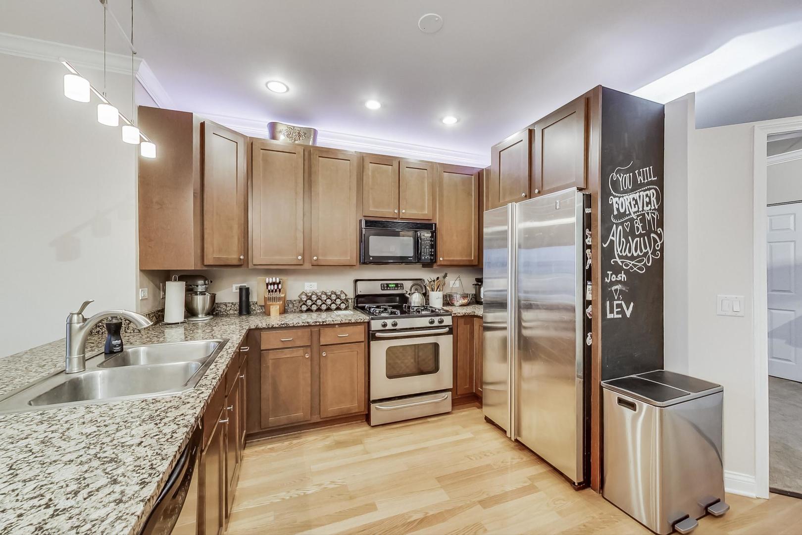 8 West Monroe Street, Unit 2008 Chicago, IL 60603 - Photo 5 of 18 a kitchen with stainless steel appliances granite countertop a sink stove and refrigerator