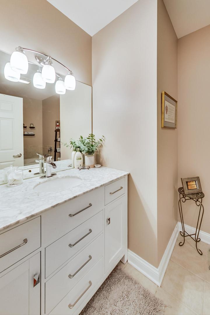 8 West Monroe Street, Unit 2008 Chicago, IL 60603 - Photo 8 of 18 a bathroom with a sink and a mirror