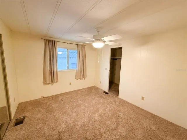 an empty room with windows and cabinet